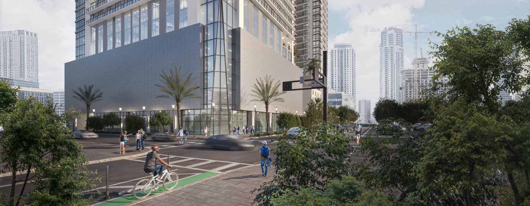 a tall building with a courtyard and people walking around